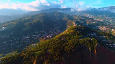 Yeşillik yemyeşil dağları ve bir sürü evi var. Kayaların üzerinde yüzen kalın bulut. Madeira Adaları Panoraması, Portekiz.