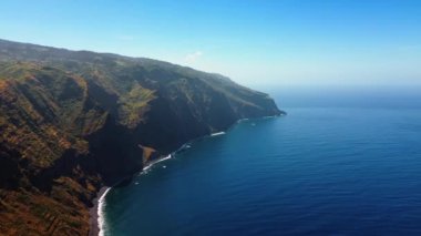 Atlantik Okyanusu kıyısındaki yüksek kayalık kayalıklar. Portekiz 'in Madeira Adaları kıyısındaki huzurlu deniz manzarasının üzerinde insansız hava aracı görüntüleri..