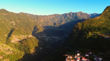 Resimli büyük dağlar samimi bir kasabayı gizler. Portekiz 'deki Madeira Adaları' ndaki muazzam kayaların muhteşem manzarası. Hava görünümü.