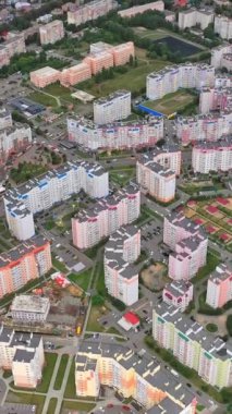 Şehir manzarası. Kentsel arka planda modern tasarım gökdelenleri. Kasabada çok katlı yeni binalar. Yukarıdan bak. Dikey video