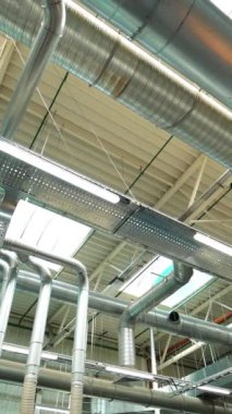 Havalandırma sistemi ve ışıkları olan endüstriyel fabrika tavanı. Havalandırma kanalları. Dikey video