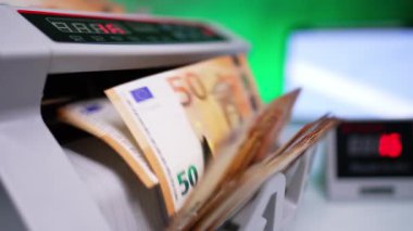 Para sayma makinesini çalıştırıyorum ve bıçaklar dönmeye başlıyor. Kapatın. Banka ekipmanlarında 50 euro para sayıldı.