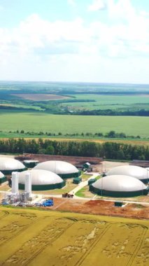 Biyolojik gaz üretimi için yeni tarım kompleksi. Yenilikçi biyo-gaz santrali biyokütleden yenilenebilir enerji. Hava görüntüsü. Dikey video