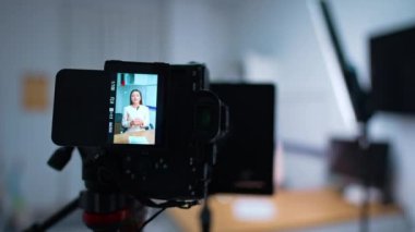 Sergilenen bir kadınla profesyonel kamerada çalışıyor. Kapatın. İçerik oluşturma günlüğü. Bulanık arkaplan.