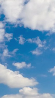 Atmosferde hafif, beyaz bulutlar. Düşük açılı görüntüden hızlı bulutsal oluşum. Zaman ayarlı. Dikey video