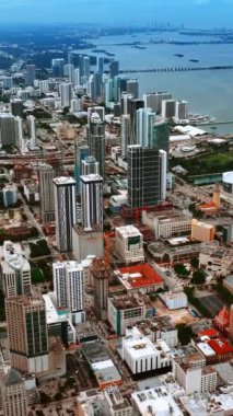 Miami 'nin engin manzarası. Suyun üzerinde birden fazla iskele var. Modern ABD şehrinde geniş bir mimari yelpazesi var. Dikey video