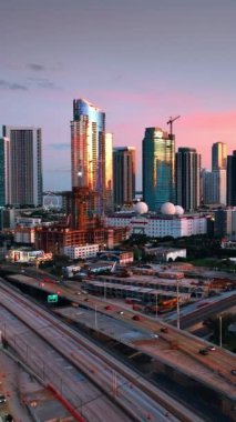Güneşin batışını yansıtan muhteşem gökdelenleri olan modern şehir manzarası. Miami, Florida, ABD 'nin muhteşem manzarası. Dikey video