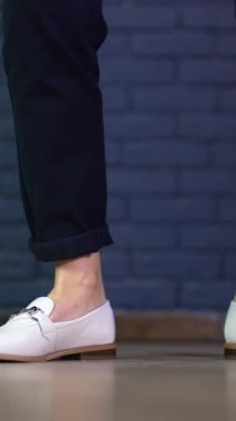 Dans eden ayakkabıları yakından izle. Yerde dans eden yaşam tarzı ayakkabıları. Dikey video