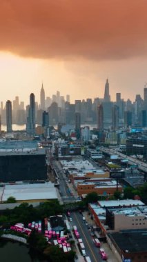 Akşamları New York Panoraması. Gökyüzünü kaplayan pembe bulutlu bir manzara. Üst Manzara. Dikey video