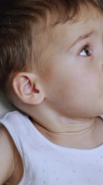 Anne oğluna bir kaşık veriyor ama o geri dönüyor. Çocuk yemeği alır ve ağzında tutar. Portreyi kapat. Dikey video