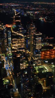 Geceleri muhteşem New York 'un engin manzarası. Karanlık Doğu Nehri şehri ışıklarla dolduruyor. Üst görünüm.