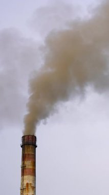 Endüstriyel üretimin kirliliği. Bulutlu gökyüzüne karşı gaz borusu santrali. Dikey video