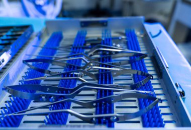 Neurosurgery tools arranged. Various surgical instruments are neatly arranged on a tray in a neurosurgery operating room, ready for the procedure.