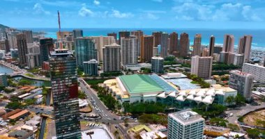 Modern güneşli Honolulu, Hawaii, ABD sokaklarında çok sayıda araba hareket ediyor. Waikiki 'nin yüksek binaları turkuaz su manzarasının arka planında. Hava görünümü.