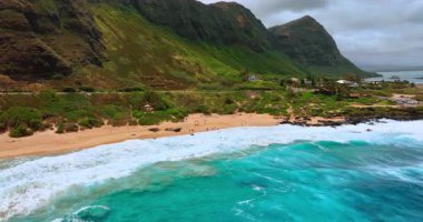 Yeşil dağların, kumlu sahillerin ve kıyıya vuran turkuaz dalgaların ikonik kombinasyonu. Hawaii 'nin inanılmaz kıyıları, ABD. Hava görünümü.