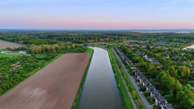 Resimli manzaradaki kanalın üzerindeki görüntüler. Kanalın çevresindeki güzel doğa, köy ve tarım alanları. Üst görünüm.