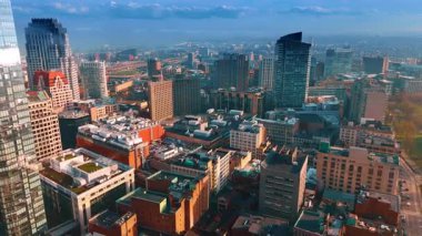 Modern Boston, MA, ABD 'nin çeşitli binalarının tepelerinden uçuyor. Şehrin uçsuz bucaksız manzarası, ufukta sis var..