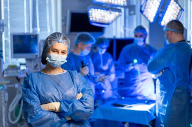 Cerrahlar birlikte çalışır. Bir tıbbi ekip, karmaşık bir ameliyat sırasında hasta bakımı ve hassasiyetine odaklanmak için cerrahi bir odada işbirliği yapıyor..