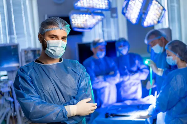 Modern bir ameliyathanede cerrahi ekip. Bir cerrahi ekibi, iyi aydınlatılmış bir ameliyathanede gelişmiş tıbbi ekipman ve odaklanmış takım çalışması ile bir prosedür yürütüyor..
