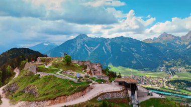 Avusturya, Tyrol, Reutte 'deki Ehrenberg Kalesi' nin kalıntılarına yaklaşıyoruz. Gri bulutların altındaki arka planda muhteşem dağlar. Hava perspektifi.