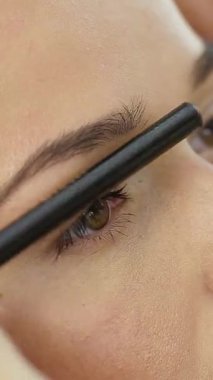 Kalıcı Makyaj Kaşları. Kozmetik uzmanı kaşlarına kalıcı makyaj uyguluyor.