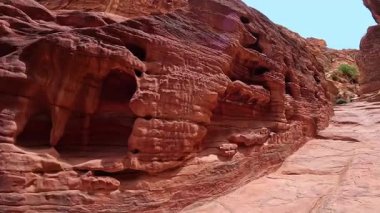 Rüzgâr ve kumun gücüyle kıvrılan delikli ve çizgili etkileyici kumtaşları var. Petra, Ürdün, Batı Asya 'da çarpıcı kaya oluşumları.