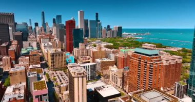 Chicago şehir manzarasında demiryolu tarafından hasılatı yapılan çok katlı binalar. Şehir merkezinde yüksek binalar ve arka planda mavi göl manzarası. Hava görünümü.