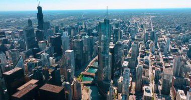 Güneşli bir günde Şikago manzarası. Şikago Nehri 'nin üzerinden inen insansız hava aracı görüntüleri yüksek katlı şehri geçiyor..