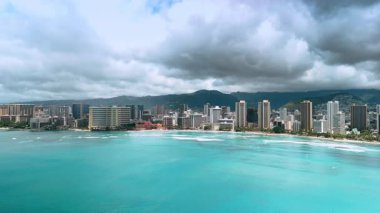 Waikiki, Honolulu, Hawaii, ABD manzarasının üzerinde dramatik bulutlar toplandı. Pasifik Okyanusu 'nun turkuaz su manzarasının üstündeki insansız hava aracı görüntüleri..