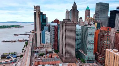 Doğu Nehri 'nin çeşitli binalarıyla yoğun bir şekilde inşa edilmiş. Arabalar nehir boyunca yol boyunca hareket eder. New York, ABD.