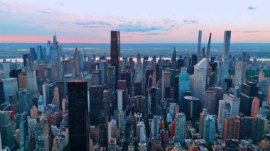 Günbatımında Manhattan, New York, ABD 'nin etkileyici manzarası. Pembe gökyüzünün altındaki metropol üzerine hava perspektifi. Doğu Nehri, arka planda..