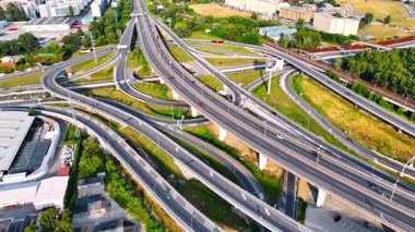 Avrupa 'da karmaşık otoyol kavşağı. Güneşli bir günde kentsel bir Avrupa ortamında birden fazla şerit ve bağlantıyla yoğun bir karayolu kavşağı görüntüsü.