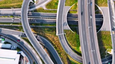 Kentsel alanda karmaşık yol kavşağı. Karmaşık yollarda ilerleyen birden fazla şerit ve araçla dolu yoğun bir yol kavşağının hava görüntüsü.