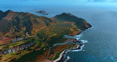 Pasifik Okyanusu kıyısının muhteşem manzarası. Resimli vadi ve dağların birleşimi. Manzaranın önünden geçen otoyolun yakınındaki yerleşim bölgesine bakın. Honolulu, Hawaii, ABD.