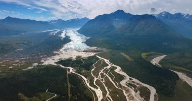 İnsansız hava aracı görüntülerinden Alaska 'nın vahşi doğası. Muhteşem dağ sıralarının eteğindeki vadide akan dallanan nehre bakın..