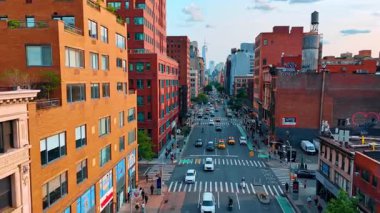 Araba akışı caddeden geçerek kameraya yaklaşıyor. Yoğun yolda sarı taksi ve arabalarla İHA uçuşu. New York, ABD.