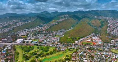 Honolulu, Hawaii, ABD manzaralı yemyeşil dağlar. Şehrin üzerinde dramatik bulutlu bir hava..