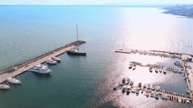 Rıhtımda duran çeşitli su araçları. Rıhtımda yatlar, tekneler, jet ski scooterları. Hava görünümü.