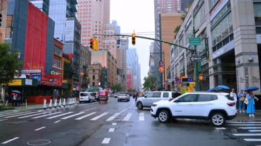 Yağmurlu bir günde New York 'un işlek sokakları. Metropolün yollarında ve kaldırımlarında çok sayıda insan ve araba var..