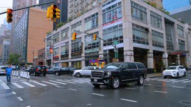 New York sokakları ve kavşaklarında sarı sokak lambaları var. Gündüz vakti metropol yollarında trafik.