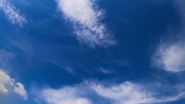 İnanılmaz mavi gökyüzünde hafif küçük bulutlar. Rüzgarlı bir yaz günü düşük açılı bir gökyüzünden. Zaman Uygulaması.