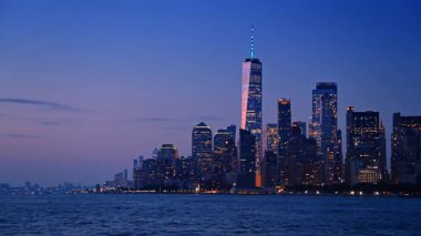 Çarpıcı New York, alacakaranlıkta ışıkları açıyor. Doğu Nehri rıhtımında ışıkları açık olan güzel, modern gökdelenler..