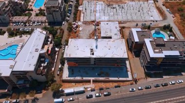 Deniz kıyısındaki inşaat alanında. Turnaları, çelik iskeleti ve işçilerinin bulunduğu bir kıyı inşaat projesi.