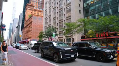 New York, USA, 1 August 2025: Cadillac SUV in traffic near Brooklyn Diner Manhattan. Cadillac SUV in traffic near Brooklyn Diner Manhattan