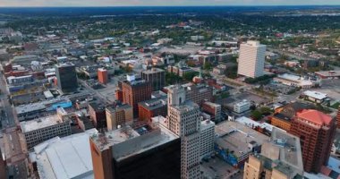 Footage above the average modern city. Drone flight over Toledo, Ohio, USA at sunset.