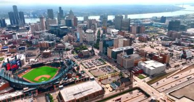 Beautiful downtown of Detroit with sport stadium and arena. Flight over the urban landscape on sunny day.