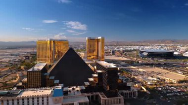 Las Vegas, USA, 11 September 2025: Beautifully designed building of the Luxor Las Vegas Hotel and Casino. Golden-faade high-rise of Mandalay Bay at backdrop. Aerial view on Las Vegas, Nevada, USA.