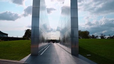 New York, USA, 11 September 2025: Approaching the twin walls of Empty Sky Memorial in Liberty State Park in Jersey City, USA. Names of the victims of the terrorist attack are inscribed on the metal walls.