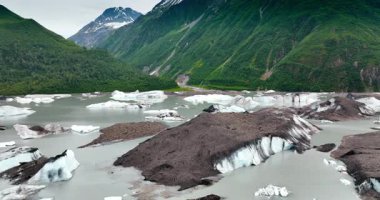 Waterscape in the mountains with boulders of ice sticking out of. Wild nature of Alaska, USA.