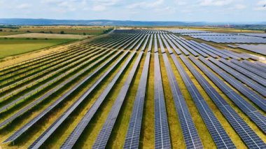 Expansive solar field installation. Massive lines of solar panels designed to generate clean power efficiently.